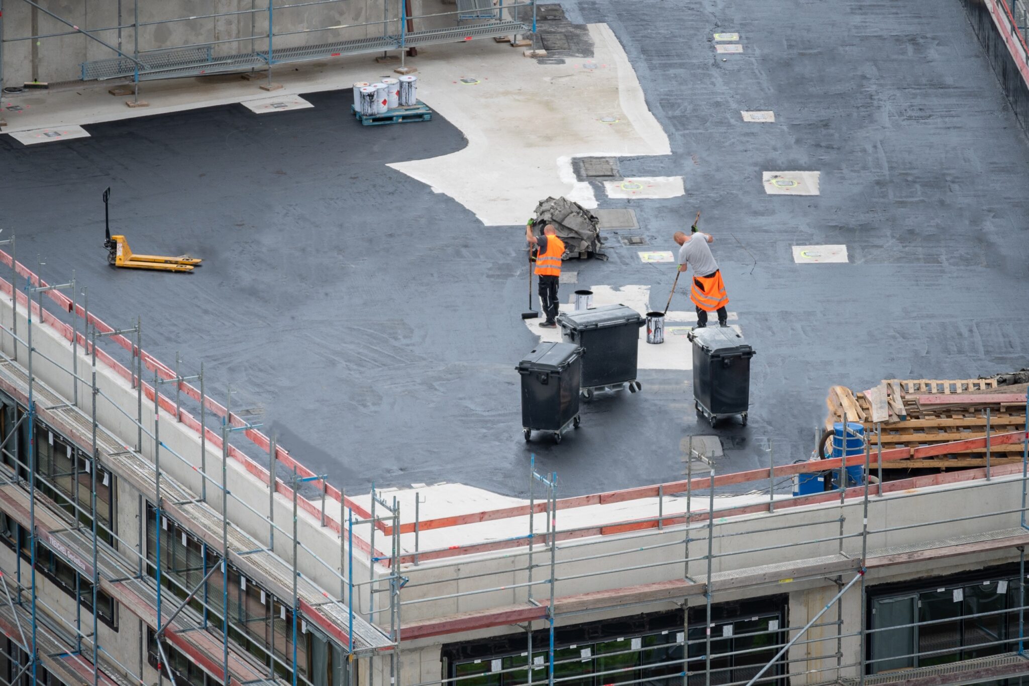 Brazos thermal construction workers refinishing a commercial roof.