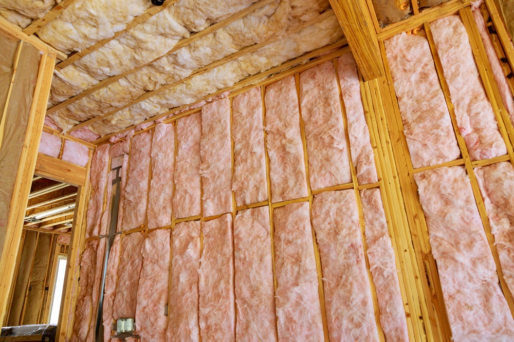 Image of fiberglass batt insulation laid in the hollow walls of a new residential house.