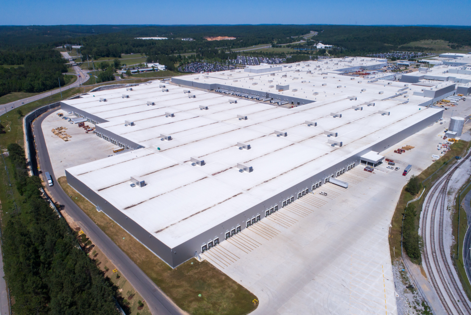 White industrial roof coated in high performance spray foam by Brazos Thermal.