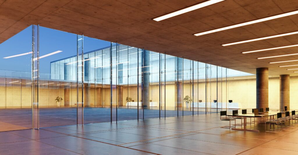 A commercial building with a conference table and floor to ceiling windows.