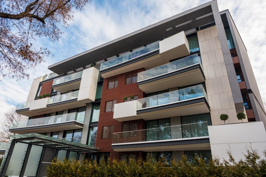 A low angle view of a modern building with glass balconies.