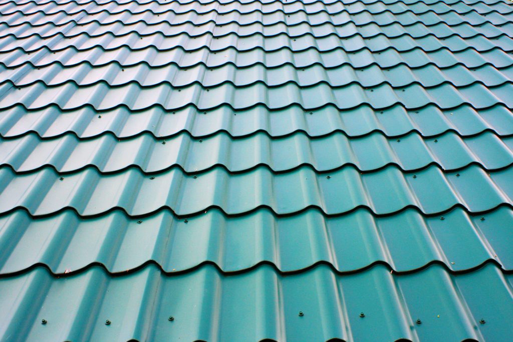 A close-up of blue-green metal roof tiles.