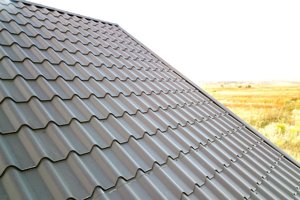 A black metal roof on a building in a remote area.